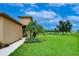 Landscaped side yard with walkway leading to house entrance at 2403 Richmond Greens Ct, Sun City Center, FL 33573