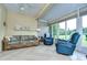 Relaxing sunroom with wicker furniture and tranquil views at 2403 Richmond Greens Ct, Sun City Center, FL 33573