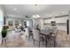 Open dining area with hardwood floors, staged furniture, and view into kitchen at 5607 Limelight Dr, Apollo Beach, FL 33572