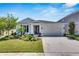 Beautiful two-story house with a two-car garage and well-manicured lawn at 5607 Limelight Dr, Apollo Beach, FL 33572