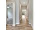 Long hallway with tile floors, leading to other rooms and areas of the home at 5607 Limelight Dr, Apollo Beach, FL 33572