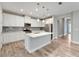 Modern kitchen with white cabinets, quartz countertops, and stainless steel appliances at 5607 Limelight Dr, Apollo Beach, FL 33572