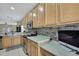 Kitchen boasts light wood cabinets, stainless steel appliances, and a built-in desk area at 20308 Oak Key Ct, Tampa, FL 33647