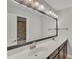 Double vanity bathroom with large mirror and updated lighting at 10142 Kingsbridge Ave, Tampa, FL 33626