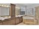 Elegant bathroom with double vanity, soaking tub, and walk-in shower at 10142 Kingsbridge Ave, Tampa, FL 33626