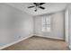 Bedroom with ceiling fan and neutral carpeting at 10142 Kingsbridge Ave, Tampa, FL 33626