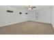 Spacious bedroom with ceiling fan and neutral carpeting at 10142 Kingsbridge Ave, Tampa, FL 33626