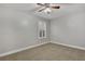 Spacious bedroom with ceiling fan and window shutters at 10142 Kingsbridge Ave, Tampa, FL 33626