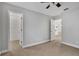 Bedroom with ceiling fan, neutral carpeting, and walk-in closet at 10142 Kingsbridge Ave, Tampa, FL 33626