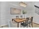 Bright dining room with wood table and statement chandelier at 10142 Kingsbridge Ave, Tampa, FL 33626