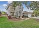 Two-story house with gray siding, white garage door, and landscaping at 10142 Kingsbridge Ave, Tampa, FL 33626