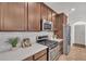 Modern kitchen with dark wood cabinets, stainless steel appliances, and white countertops at 10142 Kingsbridge Ave, Tampa, FL 33626