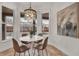 Bright kitchen nook with a white table and four brown chairs, overlooking the pool at 10142 Kingsbridge Ave, Tampa, FL 33626