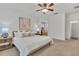 Bright main bedroom with king-size bed and ceiling fan, near the en-suite bathroom at 10142 Kingsbridge Ave, Tampa, FL 33626