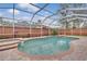 Relaxing kidney-shaped pool with a screened enclosure at 10142 Kingsbridge Ave, Tampa, FL 33626