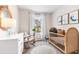 Well-lit Bedroom with a round area rug, wicker crib, rocking chair, and coastal-themed decorations at 17765 Crescent Moon Loop, Lakewood Ranch, FL 34211