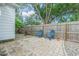 Small, brick paved patio with two chairs and a wood fence at 2367 Woodlawn W Cir, St Petersburg, FL 33704