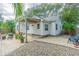 Relaxing backyard patio with brick pavers, covered seating area, and mature landscaping at 2367 Woodlawn W Cir, St Petersburg, FL 33704