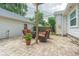 Brick paved patio with seating area and partial view of home's exterior at 2367 Woodlawn W Cir, St Petersburg, FL 33704