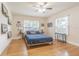 Cozy bedroom with hardwood floors, a comfortable bed, and charming decor at 2367 Woodlawn W Cir, St Petersburg, FL 33704