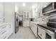 Modern kitchen with white cabinets and stainless steel appliances at 2367 Woodlawn W Cir, St Petersburg, FL 33704