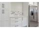 White kitchen cabinets and stainless steel refrigerator at 2367 Woodlawn W Cir, St Petersburg, FL 33704