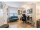 Home office with teal couch, desk, and ample natural light at 2367 Woodlawn W Cir, St Petersburg, FL 33704