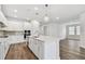 Modern kitchen with white cabinets, quartz countertops, and stainless steel appliances at 11814 Richmond Trl, Parrish, FL 34219
