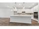 Modern kitchen with white cabinets, quartz countertops, and stainless steel appliances at 11814 Richmond Trl, Parrish, FL 34219