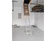 Garage attic with pull-down stairs and ample storage space at 16850 Whisper Elm St, Wimauma, FL 33598
