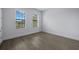 Well-lit bedroom with wood floors and two windows at 207 Chippewa Ave, Tampa, FL 33606