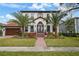 Two-story house with palm trees and brick pathway at 207 Chippewa Ave, Tampa, FL 33606