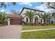 Two-story house with a brown door and palm trees at 207 Chippewa Ave, Tampa, FL 33606