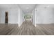 Long hallway with light gray walls and wooden floors at 207 Chippewa Ave, Tampa, FL 33606