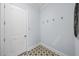 Hallway with patterned tile floor and coat hooks at 207 Chippewa Ave, Tampa, FL 33606