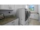 Laundry room with granite countertop and white cabinets at 207 Chippewa Ave, Tampa, FL 33606