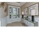 Bright entryway with white door, console table, and wood-look tile at 4504 Isonzo Way, Wesley Chapel, FL 33543