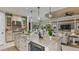 Kitchen features a large island with seating and stainless steel appliances at 4504 Isonzo Way, Wesley Chapel, FL 33543