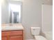 Clean bathroom with wood vanity and tub at 4978 White Sanderling Ct, Tampa, FL 33619