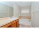 Clean bathroom with tub, toilet, and wood vanity at 4978 White Sanderling Ct, Tampa, FL 33619