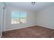 Bright bedroom with carpeted floor and large window at 4978 White Sanderling Ct, Tampa, FL 33619