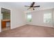 Primary bedroom with ceiling fan and ensuite bath at 4978 White Sanderling Ct, Tampa, FL 33619