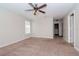 Bedroom with ceiling fan and access to hallway at 4978 White Sanderling Ct, Tampa, FL 33619