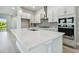 Modern kitchen with white cabinets and a large island at 6258 Broad Field Ave, Apollo Beach, FL 33572