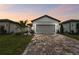 House exterior featuring a gray garage door and brick driveway at 9415 Coastline Way, Parrish, FL 34219