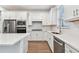 Modern kitchen with white cabinets, quartz countertops, and stainless steel appliances at 9415 Coastline Way, Parrish, FL 34219