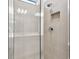 Clean shower with neutral tile and frameless glass enclosure at 9415 Coastline Way, Parrish, FL 34219