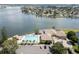 Aerial view of the clubhouse, pool, hot tub, and parking lot near the waterway at 9495 Blind Pass Rd # 206, St Pete Beach, FL 33706