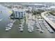 Beautiful aerial view of the waterfront condo building and boat docks with boat slips available at 9495 Blind Pass Rd # 206, St Pete Beach, FL 33706