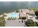 Aerial view of the clubhouse, pool, hot tub, and parking lot near the waterway at 9495 Blind Pass Rd # 206, St Pete Beach, FL 33706